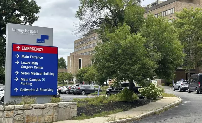 A direction board stands outside Carney Hospital in Boston, Tuesday, Aug. 20, 2024. (AP Photo/Nick Perry)