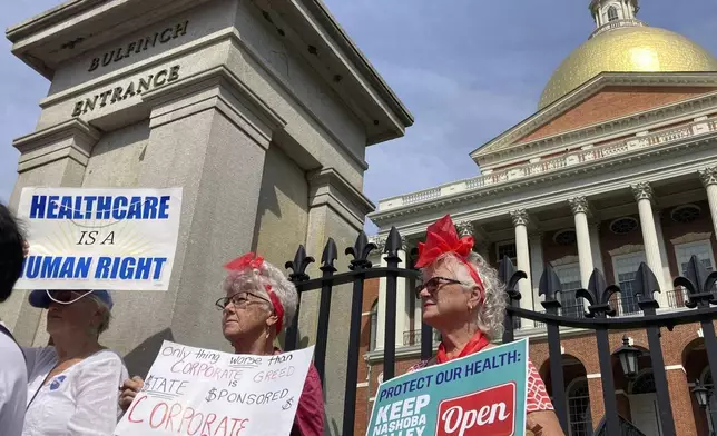 Protesters wanting to keep two Massachusetts hospitals open gather in front of the statehouse in Boston on Wednesday, Aug. 28, 2024. (AP Photo/Steve LeBlanc)