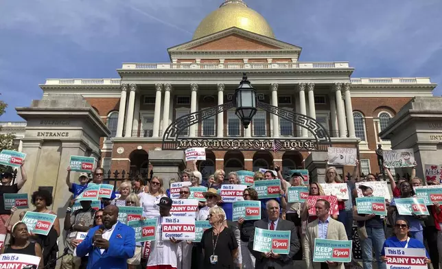 Protesters wanting to keep two Massachusetts hospitals open gather in front of the statehouse in Boston, Wednesday, Aug. 28, 2024. (AP Photo/Steve LeBlanc)