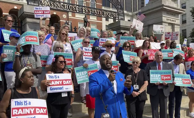 Protesters wanting to keep two Massachusetts hospitals open gather in front of the statehouse in Boston on Wednesday, Aug. 28, 2024. (AP Photo/Steve LeBlanc)