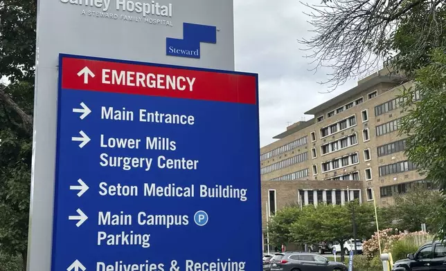 A direction board stands outside Carney Hospital in Boston, Tuesday, Aug. 20, 2024. (AP Photo/Nick Perry)