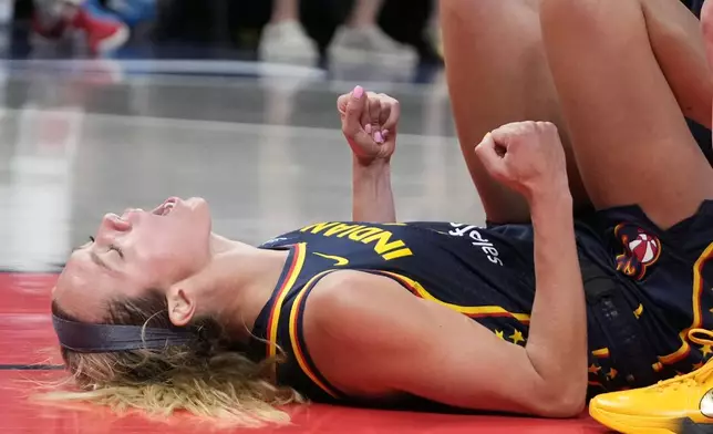 Indiana Fever's Lexie Hull reacts after taking a charging foul during the second half of a WNBA basketball game against the Seattle Storm, Sunday, Aug. 18, 2024, in Indianapolis. (AP Photo/Darron Cummings)