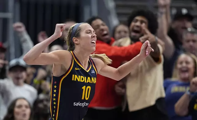 Indiana Fever's Lexie Hull reacts after hitting a 3-point basket during the second half of a WNBA basketball game against the Seattle Storm, Sunday, Aug. 18, 2024, in Indianapolis. (AP Photo/Darron Cummings)