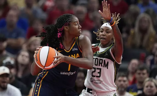 Indiana Fever's Aliyah Boston (7) is defended by Seattle Storm's Jordan Horston (23) during the second half of a WNBA basketball game, Sunday, Aug. 18, 2024, in Indianapolis. (AP Photo/Darron Cummings)