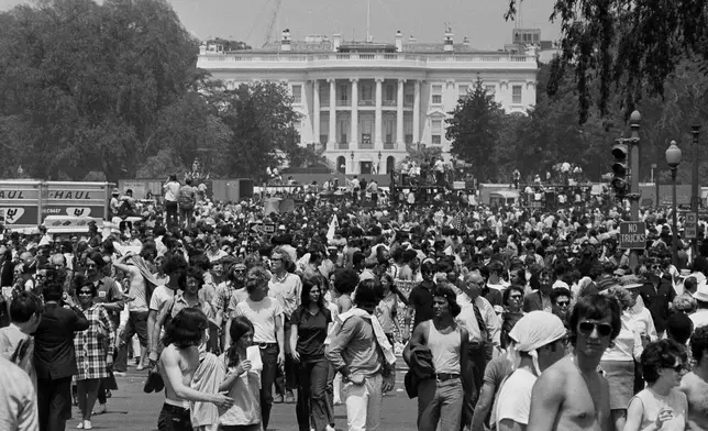 FILE -Anti-war demonstrators raise their hands toward the White House as they protest the shootings at Kent State University and the U.S. incursion into Cambodia, on the Ellipse in Washington D.C., on May 9, 1970. (AP Photo, File)