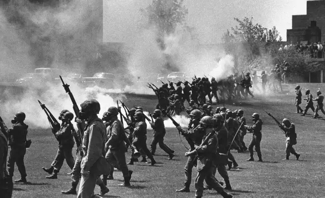 FILE - Ohio National Guard soldiers move in on war protesters at Kent State University in Kent, Ohio, on May 4, 1970. (AP Photo, File)