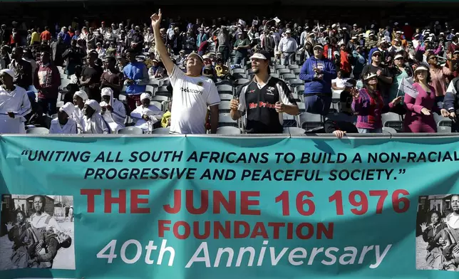 FILE -In this photo taken June 11, 2016 church members pray for victims of the June 1976 uprising as they prepare to march to mark the 40th anniversary in Soweto, South Africa. (AP Photo/Themba Hadebe, File)