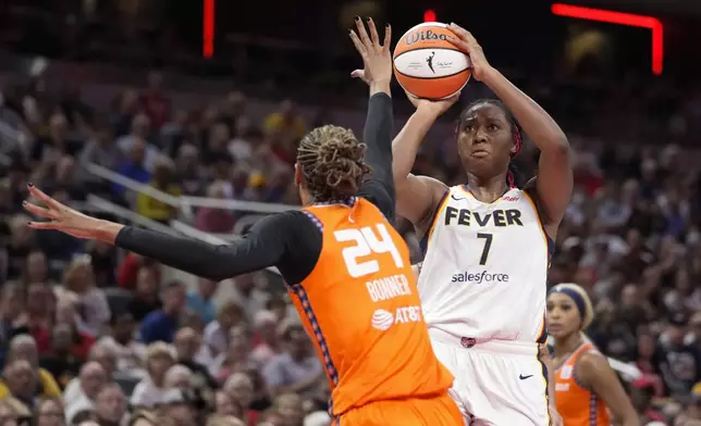 Indiana Fever forward Aliyah Boston (7) shoots over Connecticut Sun forward DeWanna Bonner (24) in the second half of a WNBA basketball game in Indianapolis, Wednesday, Aug. 28, 2024. (AP Photo/Michael Conroy)