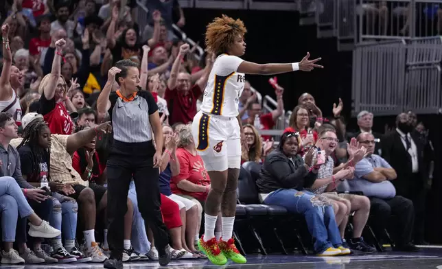 Indiana Fever forward NaLyssa Smith (1) celebrates a three-point basket against the Connecticut Sun in the first half of a WNBA basketball game in Indianapolis, Wednesday, Aug. 28, 2024. (AP Photo/Michael Conroy)