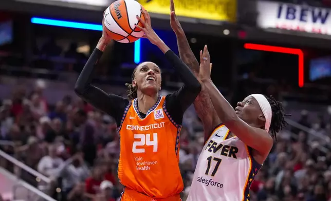 Connecticut Sun forward DeWanna Bonner (24) shoots over Indiana Fever guard Erica Wheeler (17) in the first half of a WNBA basketball game in Indianapolis, Wednesday, Aug. 28, 2024. (AP Photo/Michael Conroy)