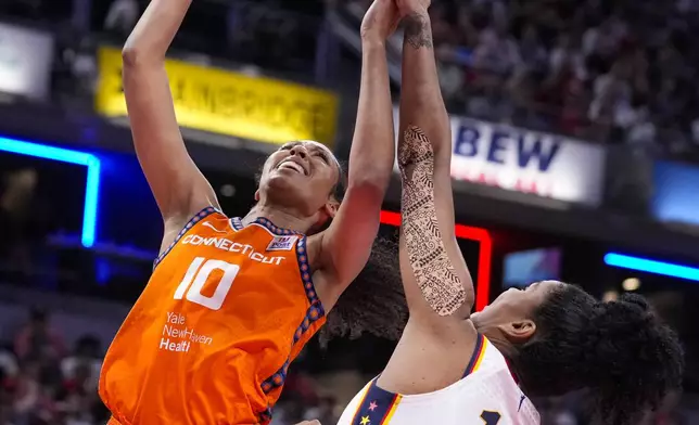 Connecticut Sun forward Olivia Nelson-Ododa (10) shoots over Indiana Fever forward Damiris Dantas (12) in the first half of a WNBA basketball game in Indianapolis, Wednesday, Aug. 28, 2024. (AP Photo/Michael Conroy)