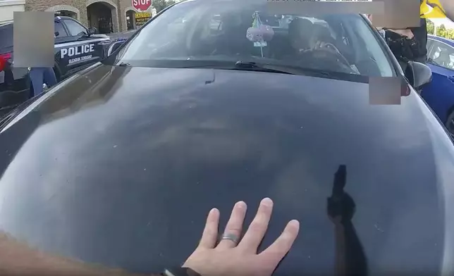 FILE - This still image from bodycam video released by the Blendon Township Police on Friday, Sept. 1, 2023, shows an officer pointing his gun at Ta'Kiya Young moments before shooting her through the windshield outside a grocery store in Blendon Township, Ohio, a suburb of Columbus, on Aug. 24. The video was pixelated by the source. (Blendon Township Police via AP, File)