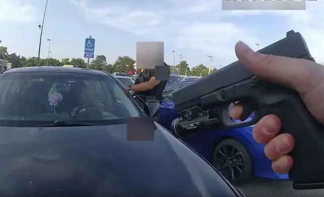 This still image from bodycam video released by the Blendon Township Police on Friday, Sept. 1, 2023, shows an officer pointing his gun at Ta'Kiya Young moments before shooting her through the windshield outside a grocery store in Blendon Township, Ohio, a suburb of Columbus, on Aug. 24. The video was pixelated by the source. (Blendon Township Police via AP, File)