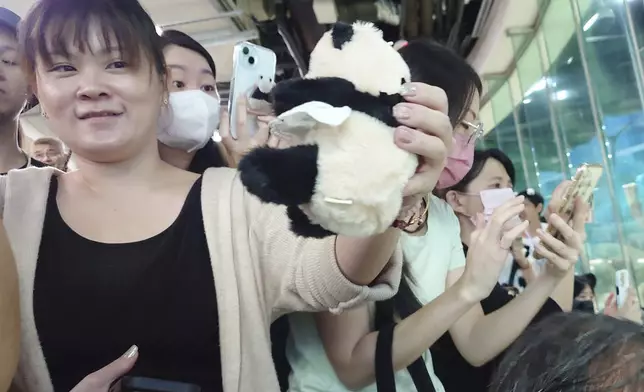 People take photos during Panda Yuanyuan''s 20-years-old birthday party at the Taipei Zoo in Taipei, Taiwan, Friday, Aug. 30, 2024. Yuanyuan was a gift from China to mark warming ties with Taiwan in 2008. (AP Photo/Chiang Ying-ying)