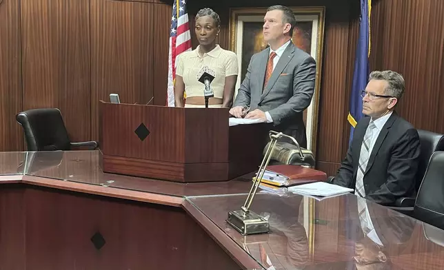 Latoreya Till, left, the mother of a 15-year-old girl who fell asleep in the Detroit courtroom of 36th District Court Judge Kenneth King, while on an Aug. 13 field trip, is suing the judge according to her attorney James Harrington, center, as they speak at a press conference in Southfield, Mich., Wednesday, Aug. 21, 2024. (Kara Berg/Detroit News via AP)