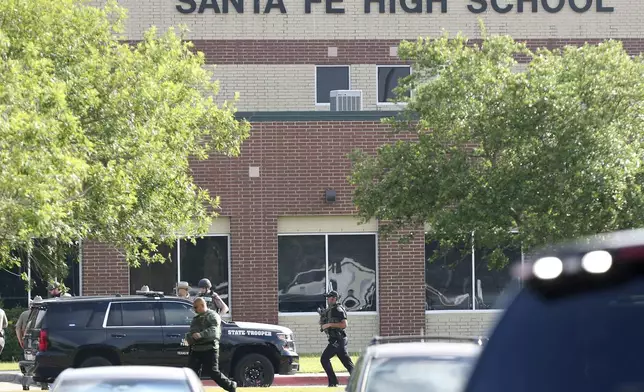 FILE - Law enforcement officers respond to Santa Fe High School after an active shooter was reported on campus in Santa Fe, Texas, May 18, 2018. A lawsuit accusing the parents of a former Texas high school student of negligence for not securing weapons he allegedly used in a 2018 shooting at his campus that killed 10 people was set to go before a jury on Wednesday, July 31, 2024. (Steve Gonzales/Houston Chronicle via AP, File)