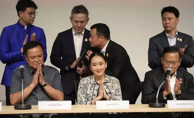 Leader of Pheu Thai Party, Paetongtarn Shinawatra, daughter of Thailand's former Prime Minister Thaksin Shinawatra, center and coalition partners gesture during press conference in Bangkok, Thailand, Thursday, Aug. 15, 2024. (AP Photo/Sakchai Lalit)