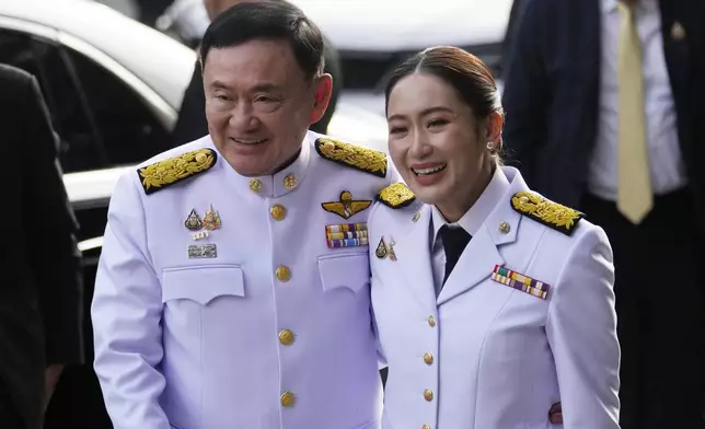 Thailand's former Prime Minister Thaksin Shinawatra, left, and his daughter and newly elected Prime Minister Paetongtarn Shinawatra arrive before the royal endorsement ceremony appointing Paetongtarn as Thailand's new prime minister at Pheu Thai party headquarters in Bangkok, Thailand, Sunday, Aug. 18, 2024. (AP Photo/Sakchai Lalit).