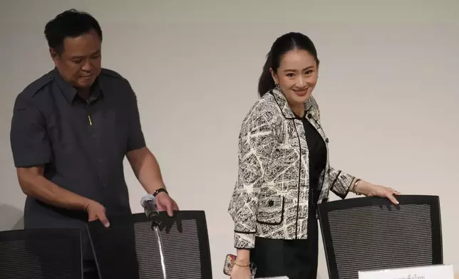 Leader of Pheu Thai Party, Paetongtarn Shinawatra, daughter of Thailand's former Prime Minister Thaksin Shinawatra, right, and coalition partners arrive for a press conference in Bangkok, Thailand, Thursday, Aug. 15, 2024. (AP Photo/Sakchai Lalit)