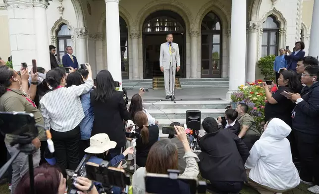 Thai Prime Minister Srettha Thavisin, center, talks to reporters during a press conference at Government house in Bangkok, Thailand after a court removed Srettha from office over an ethical violation Wednesday, Aug. 14, 2024. (AP Photo/Sakchai Lalit)