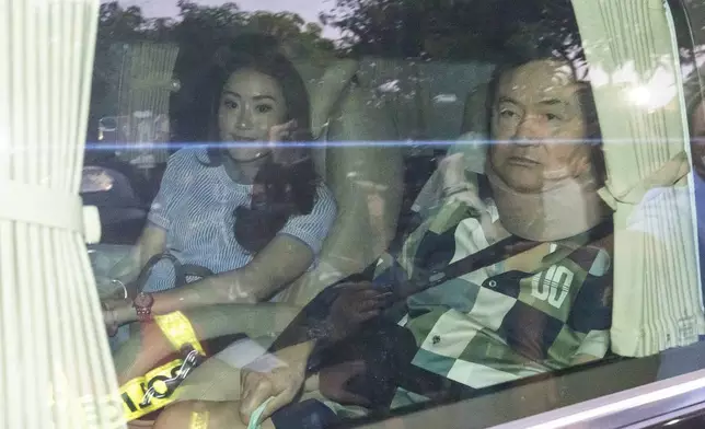 FILE - Former Thai Prime Minister Thaksin Shinawatra, right, sits in a vehicle with his daughter Paetongtarn in front of his residence after being released on parole, Sunday, Feb. 18, 2024, in Bangkok, Thailand. (AP Photo/Wason Wanichakorn File)