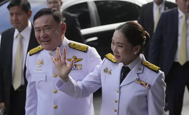 Thailand's former Prime Minister Thaksin Shinawatra, left and his daughter and newly elected Prime Minister Paetongtarn Shinawatra arrive before the royal endorsement ceremony appointing Paetongtarn as Thailand's new prime minister at Pheu Thai party headquarters in Bangkok, Thailand, Sunday, Aug. 18, 2024. (AP Photo/Sakchai Lalit)