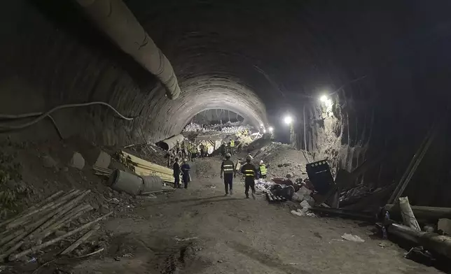 In this photo released by the State Railway of Thailand, rescuers work on Thursday, Aug. 29, 2024, the scene of a collapsed tunnel in Nakhon Ratchasima province that is part of the Thai-Chinese high-speed railway construction site. (State Railway of Thailand via AP)