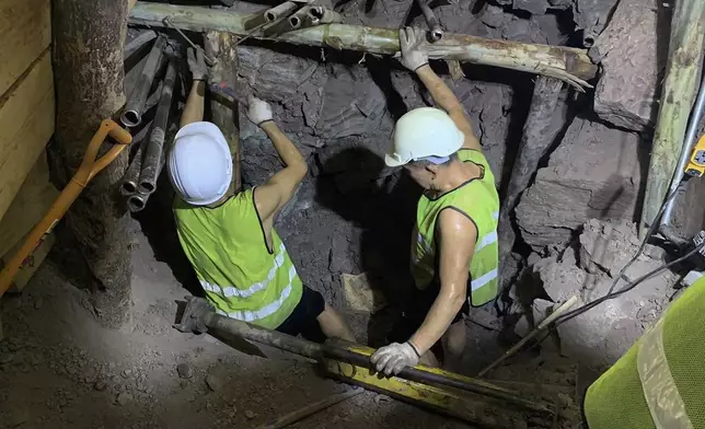 In this photo released by the State Railway of Thailand, rescuers work on Thursday, Aug. 29, 2024, the scene of a collapsed tunnel in Nakhon Ratchasima province that is part of the Thai-Chinese high-speed railway construction site. (State Railway of Thailand via AP)