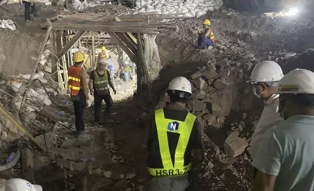 In this photo released by the State Railway of Thailand, rescuers work on Thursday, Aug. 29, 2024, the scene of a collapsed tunnel in Nakhon Ratchasima province that is part of the Thai-Chinese high-speed railway construction site. (State Railway of Thailand via AP)