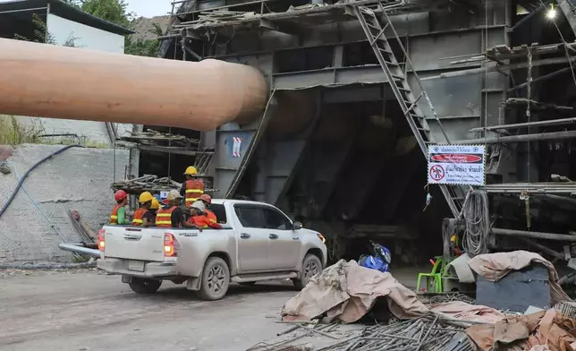 In this photo released by the State Railway of Thailand, rescuers sit on a pick-up truck Friday, Aug. 30, 2024, as they move towards the scene of a collapsed tunnel in Nakhon Ratchasima province, Thailand, that is part of the Thai-Chinese high-speed railway construction site. (State Railway of Thailand via AP)