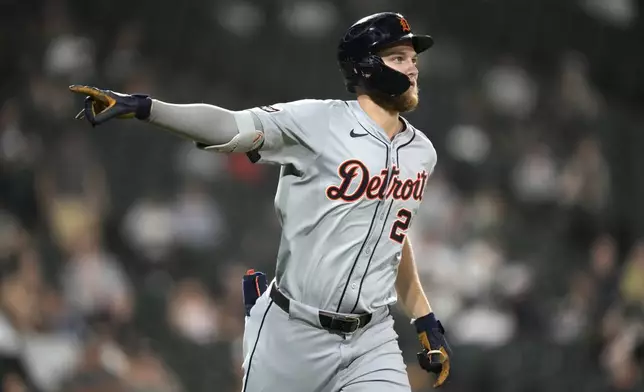 Detroit Tigers' Parker Meadows points to teammates in the dugout after his home run off Chicago White Sox relief pitcher Jared Shuster during the seventh inning of a baseball game Monday, Aug. 26, 2024, in Chicago. (AP Photo/Charles Rex Arbogast)