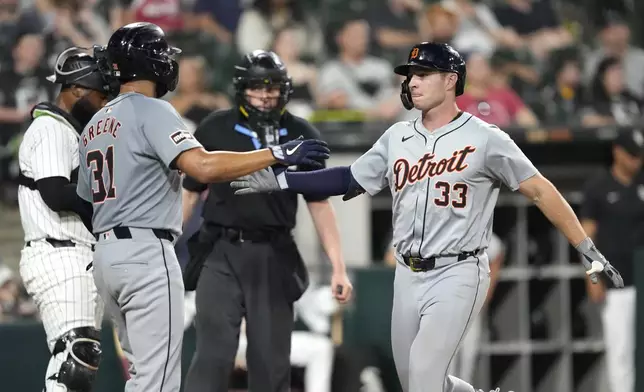 Detroit Tigers' Colt Keith (33) celebrates his two-run home run with Riley Greene, during the ninth inning of a baseball game against the Chicago White Sox on Saturday, Aug. 24, 2024, in Chicago. (AP Photo/Charles Rex Arbogast)