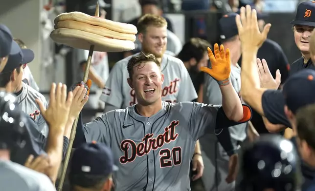 Detroit Tigers' Spencer Torkelson celebrates his three-run home run off Chicago White Sox relief pitcher Justin Anderson in the dugout during the seventh inning of a baseball game Monday, Aug. 26, 2024, in Chicago. (AP Photo/Charles Rex Arbogast)