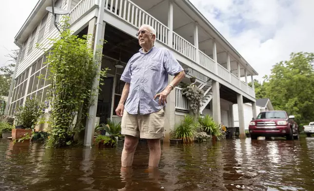 Charles Grainger cleans up around his house in the historic district of French Quarter Creek as flood waters recede from Tropical Storm Debby, Wednesday, Aug. 7, 2024, in Huger, S.C. (AP Photo/Mic Smith)