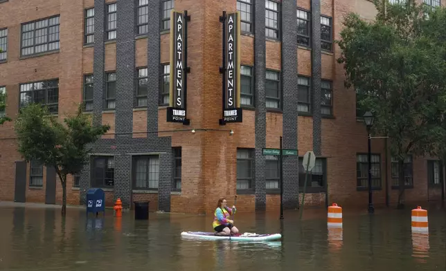 Lily Gensler goes for a paddle in Fells Point in Baltimore as the remnants of Hurricane Debby pass through Maryland, Friday, Aug. 9, 2024. (Kaitlin Newman/The Baltimore Banner via AP)