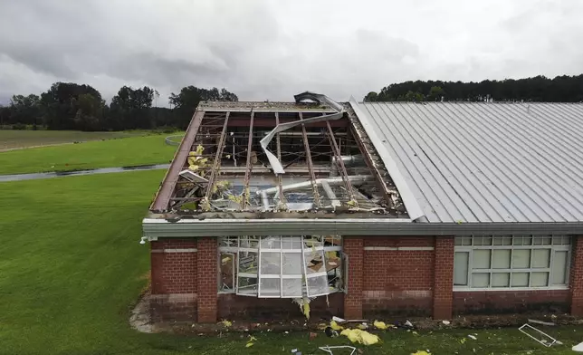 Debris from a tornado spun off by the remnants of Tropical Storm Debby, litters the campus of Springfield Middle School in Lucama, N.C., on Thursday, Aug. 8, 2024. (AP Photo/Allen G. Breed)