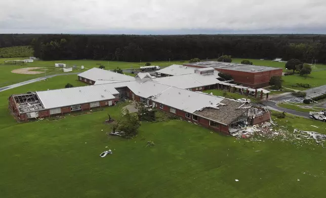 Debris from a tornado spun off by the remnants of Tropical Storm Debby, litters the campus of Springfield Middle School in Lucama, N.C., on Thursday, Aug. 8, 2024. (AP Photo/Allen G. Breed)