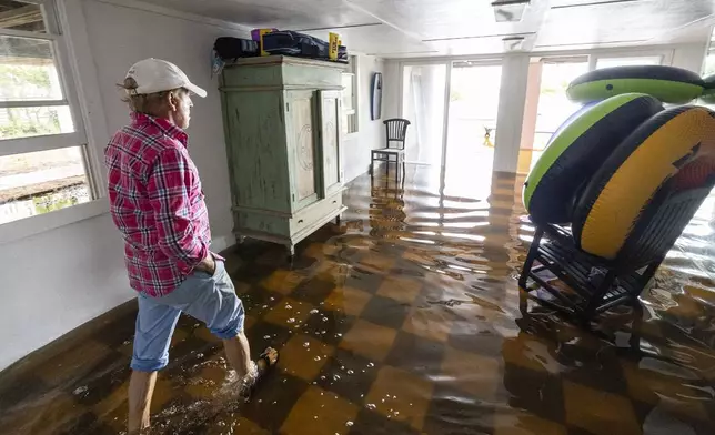 Robert Chesnut walks through water at his Palm Blvd. home after it was flooded by Tropical Storm Debby, Thursday, Aug. 8, 2024, in Isle of Palms, S.C. (AP Photo/Mic Smith)