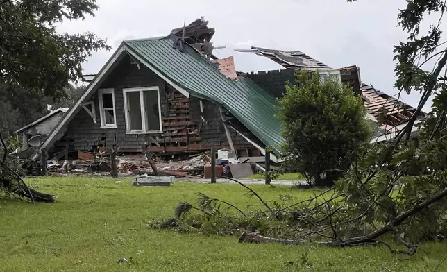 A roof collapsed on a house when a tornado hit near Lucama, N.C. as bands from Tropical Storm Debby moved through early Thursday, Aug. 8, 2024. (Travis Long/The News &amp; Observer via AP)