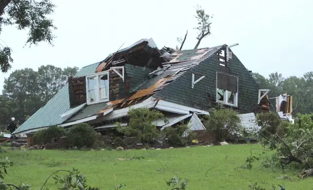 A house is damaged by a tornado spawned by Tropical Storm Debby in Wilson County, N.C. on Thursday, Aug. 8, 2024. (Christopher Long/The Wilson Times via AP)