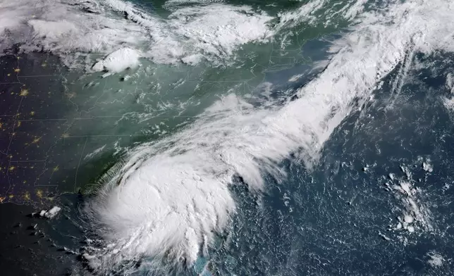 This GOES-16 GeoColor satellite image taken at 8:16 a.m. EDT and provided by National Oceanic and Atmospheric Administration (NOAA) shows Hurricane Debby, lower left, a Category 1 storm over northern Florida, Monday, Aug. 5, 2024. (NOAA via AP)