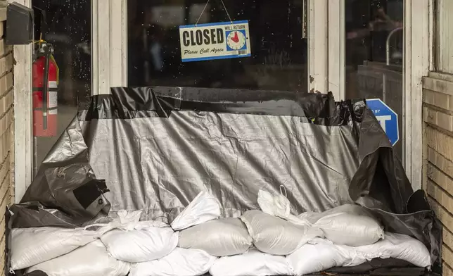 A storefront after Tropical Storm Debby passed by Thursday, Aug. 8, 2024, in Georgetown, S.C. (AP Photo/Mic Smith)