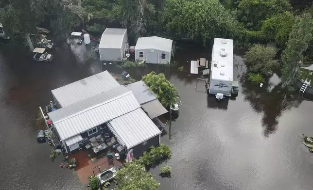 Bullfrog Creek, a tributary of the Alafie River, left some creekside homes inundated with floodwaters following Tropical Storm Debby, Tuesday, Aug. 6, 2024, in Alafia, Fla. (Max Chesnes/Tampa Bay Times via AP)