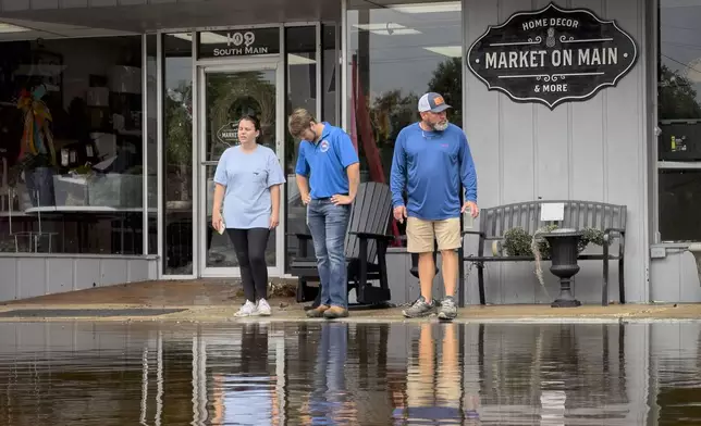 Residual rain water floods the downtown area caused by Tropical Storm Debby, Thursday, Aug. 8, 2024, in Bladenboro, NC. (AP Photo/John Minchillo)