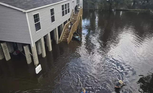 A neighborhood a half-mile from the Alafia River is inundated with waist-high water after rainfall from Tropical Storm Debby swelled the river, Tuesday, Aug. 6, 2024, in Alafia, Fla. (Max Chesnes/Tampa Bay Times via AP)