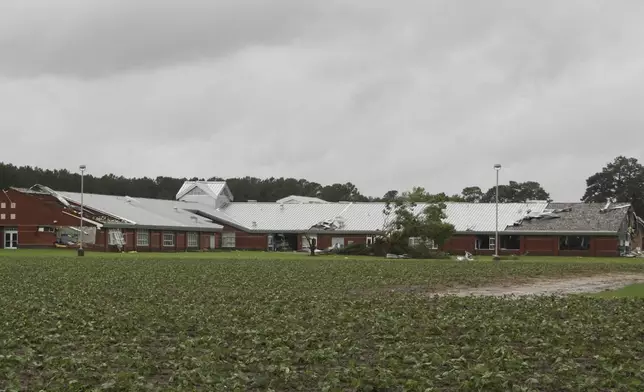 Parts of Springfield Middle School are damaged by a tornado, spawned by Tropical Storm Debby, after passing through Lucama, N.C., Thursday, Aug. 8, 2024. (AP Photo/Makiya Seminera)