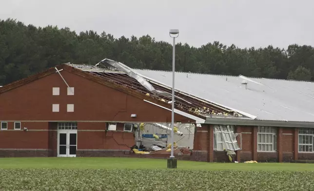 Parts of Springfield Middle School are damaged by a tornado, spawned by Tropical Storm Debby, after passing Lucama, N.C., Thursday, Aug. 8, 2024. (AP Photo/Makiya Seminera)