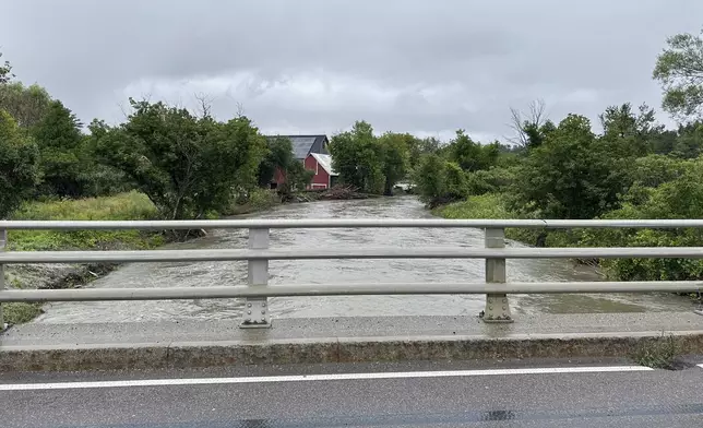 The Winooski River, swollen from precipitation from Tropical Storm Debby, is seen Friday, Aug. 9, 2024, in Plainfield, Vt. (AP Photo/Lisa Rathke)