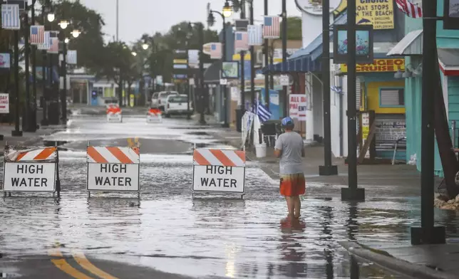 Flood water blocks a section of Dodecanese Blvd at the Tarpon Springs Sponge Docks, Monday morning, Aug 5, 2024, in Tarpon Springs, Fla., as Hurricane Debby passes the Tampa Bay area offshore. (Douglas R. Clifford/Tampa Bay Times via AP)