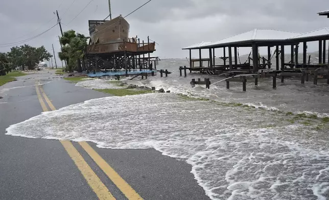 Storm surge breaks over a small sea wall near boat docks, Monday, Aug. 5, 2024, in Horseshoe Beach, Fla. Hurricane Debby made landfall early this morning.(AP Photo/Christopher O'Meara)